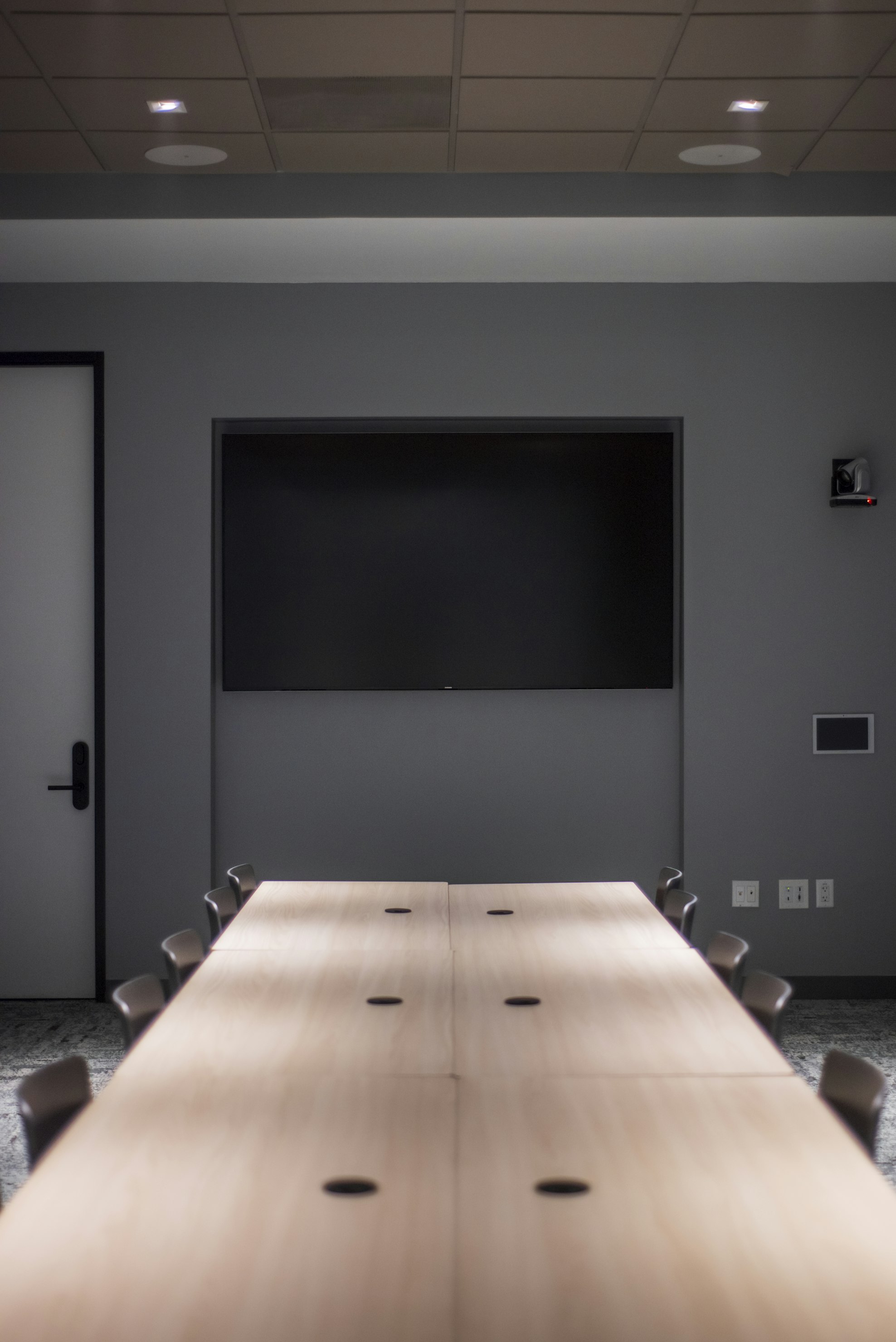 Clean white conference room with ergonomic chairs