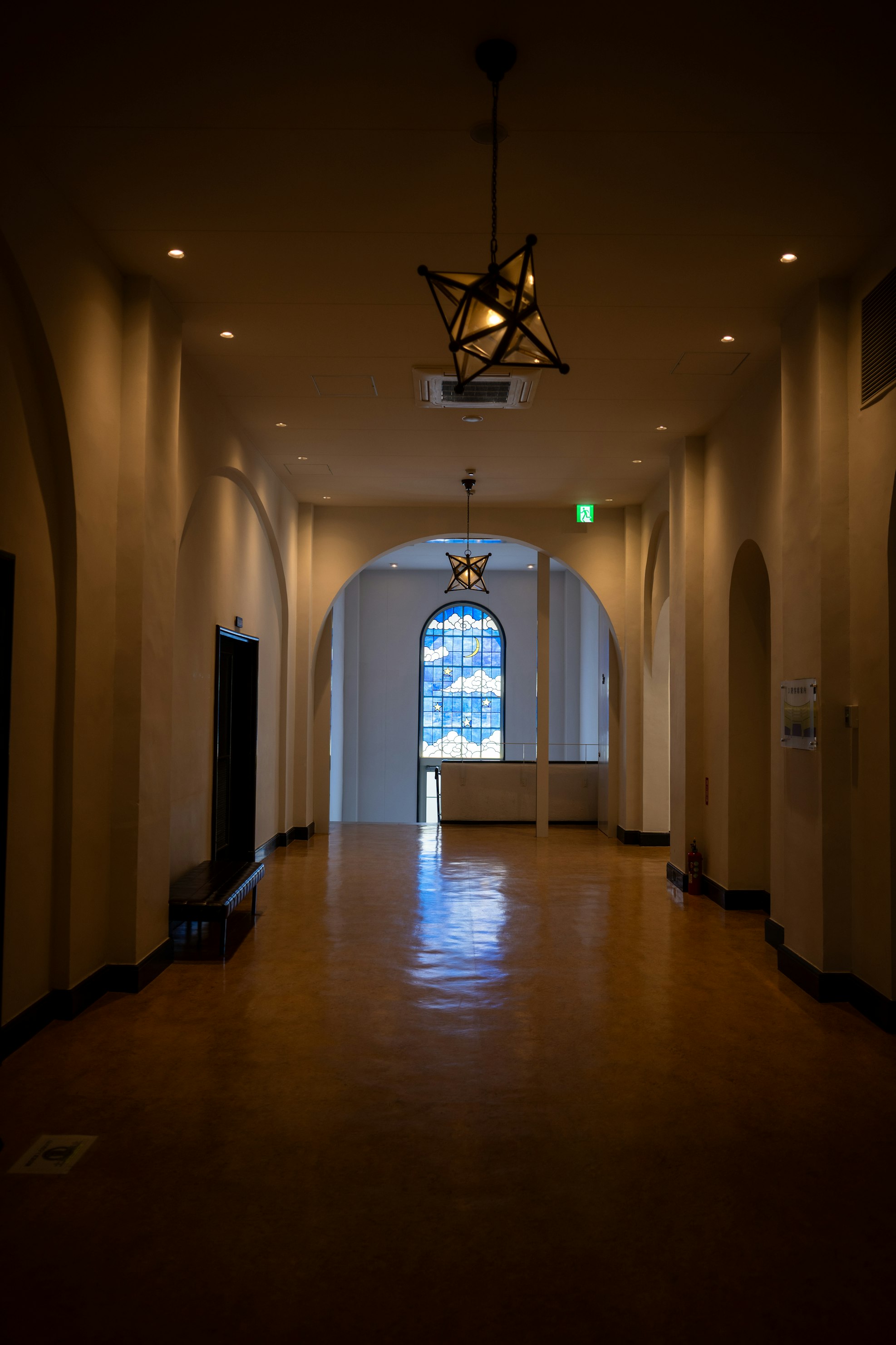 Elegant office corridor with glass partitions and plants